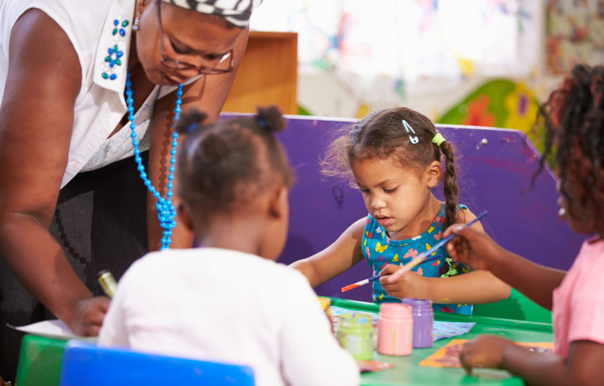 Kids in art class painting.