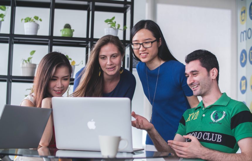 Four teachers looking at a computer