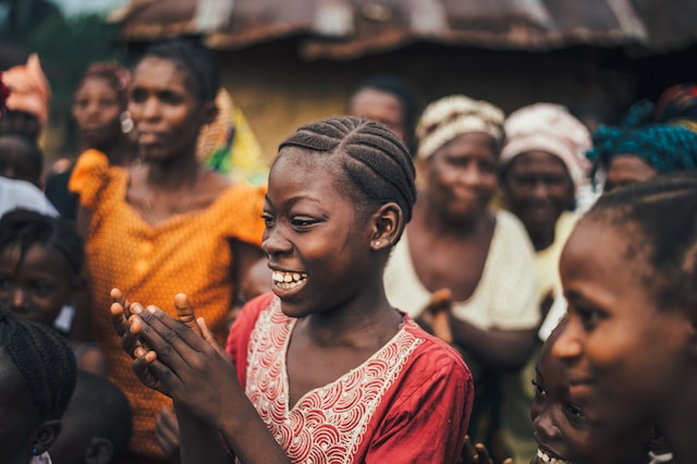 Girl smiling in a group of other girls and women