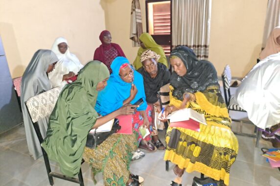 Photo of four QHL teacher fellows working together on materials