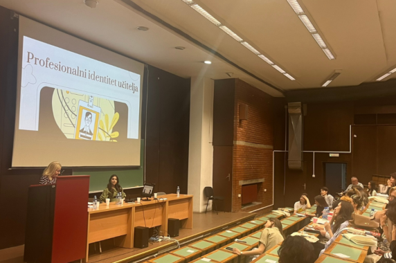 Teachers present in an auditorium at the conference.