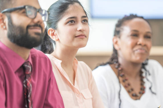 Three education leaders attending a training.