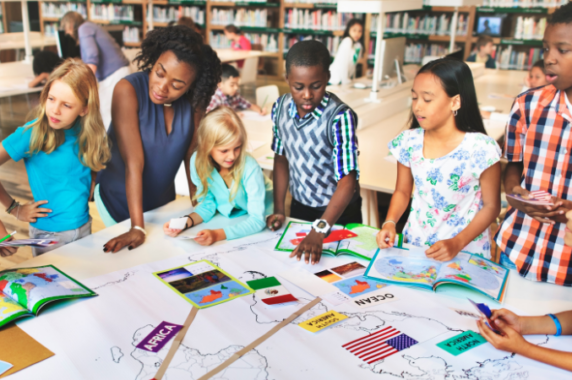 A teacher working with students in a classroom.