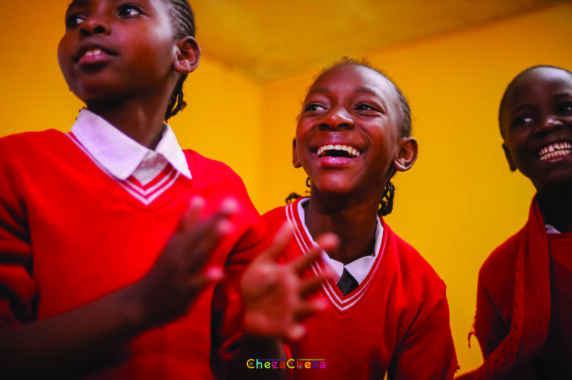 Smiling children clapping and dancing.