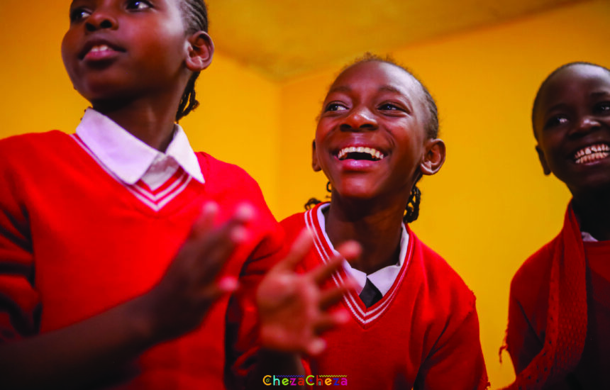 Smiling children clapping and dancing.