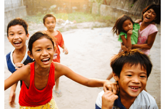 Happy children, laughing while they play outdoors.