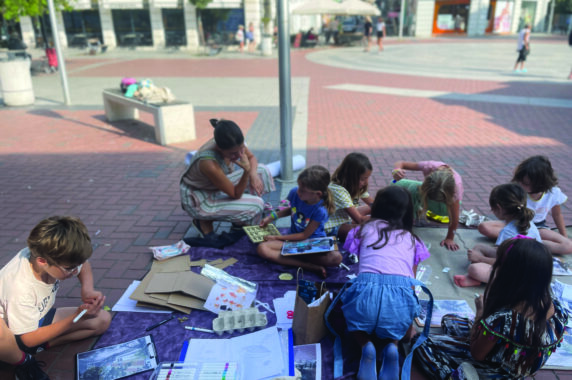 Children playing outdoors and doing art.